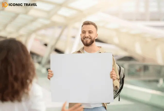 Derby to Birmingham Airport taxi driver holding a name board for meet and greet at terminal